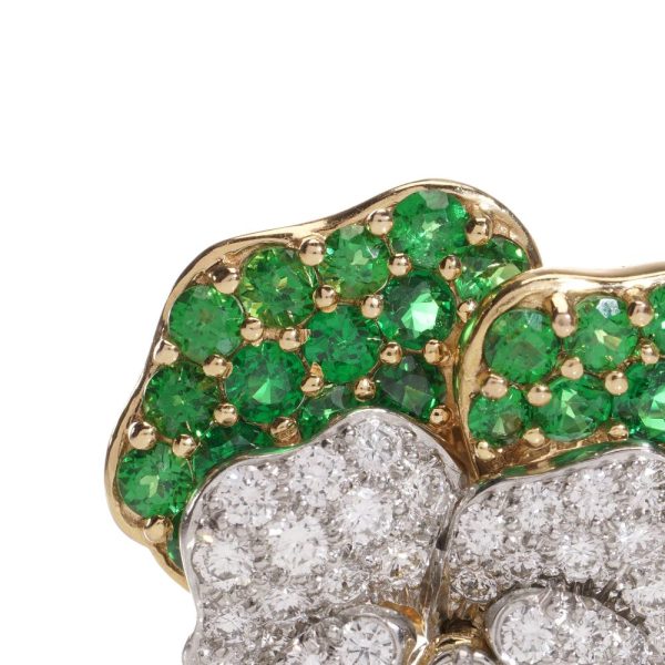 Tiffany & Co brooch in gold and platinum with tsavorite garnets, diamonds, and sapphires.