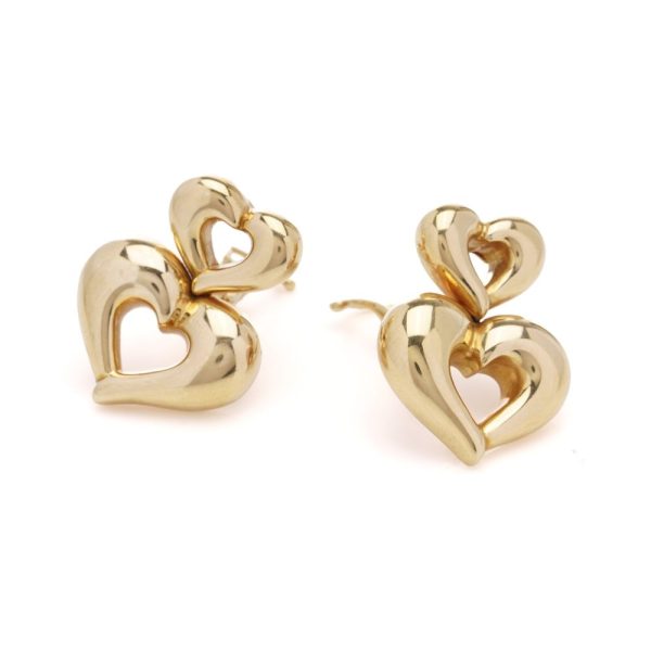 Van Cleef & Arpels clip-on earrings in gold with a heart-shaped design.