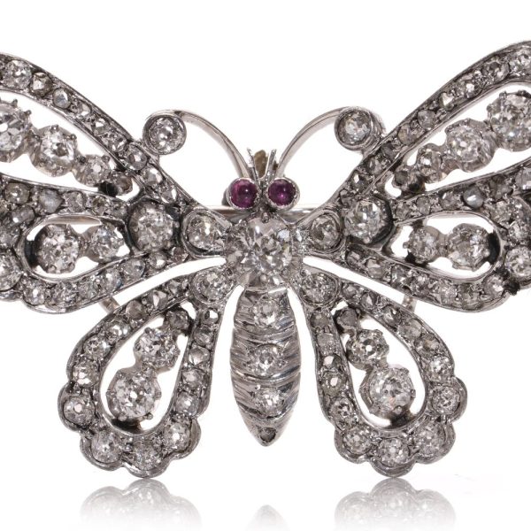 Antique white gold and silver butterfly brooch with diamonds and rubies.