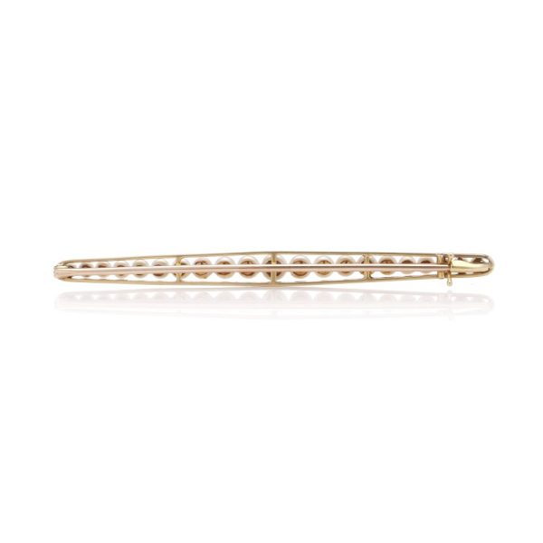 Gold and platinum elongated brooch adorned with pearls