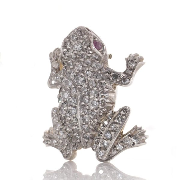 An Edwardian frog brooch in gold and silver set with diamonds and rubies.