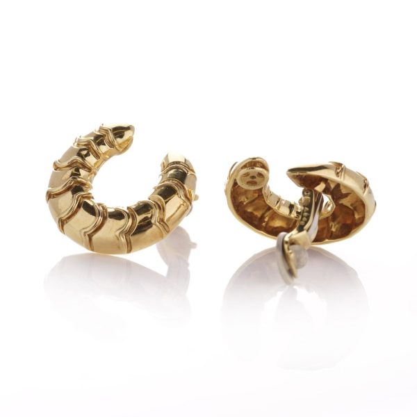 Scalloped clip earrings in gold .