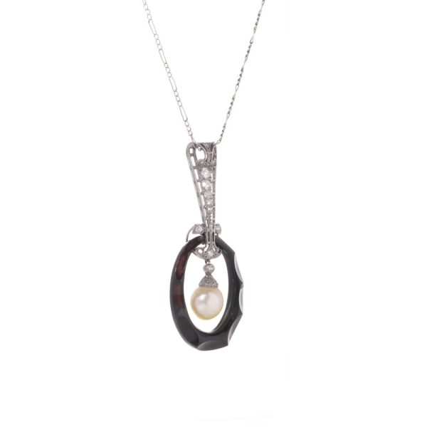 Antique platinum pendant necklace with pearl, onyx, and diamonds.