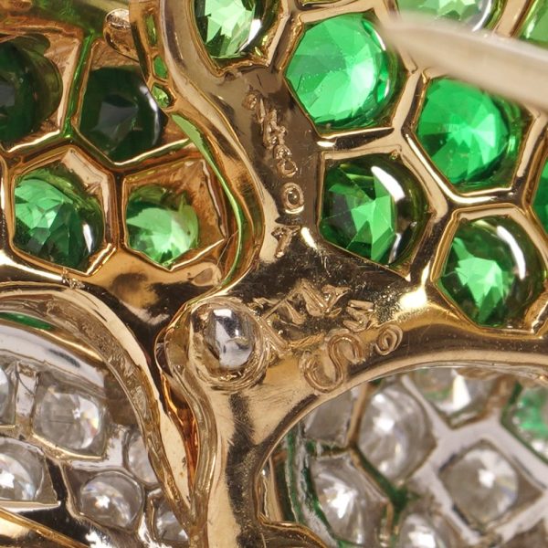 Tiffany & Co brooch in gold and platinum with tsavorite garnets, diamonds, and sapphires.