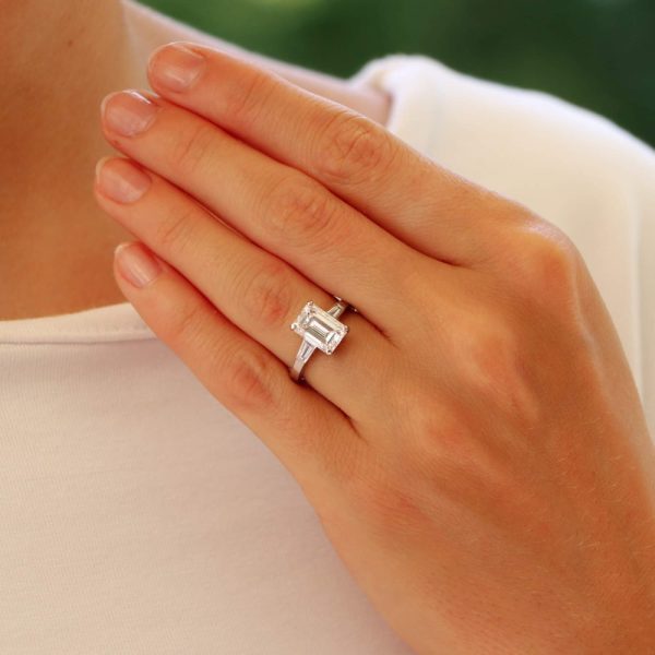 Emerald cut diamond three stone ring set in platinum.