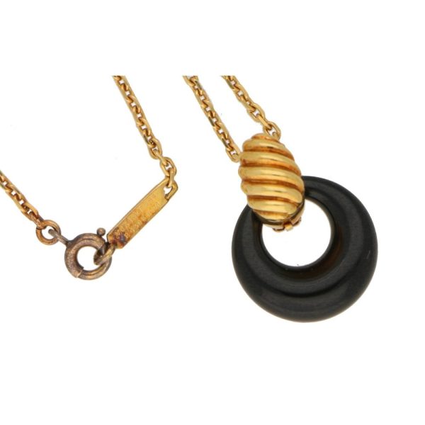 Van Cleef & Arpels onyx disk pendant necklace in gold.