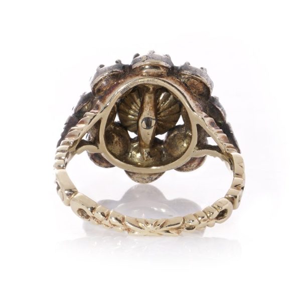 Diamond daisy cluster ring in gold and silver.