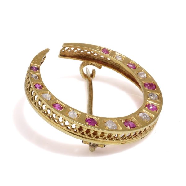 Victorian diamond and ruby crescent brooch in gold.