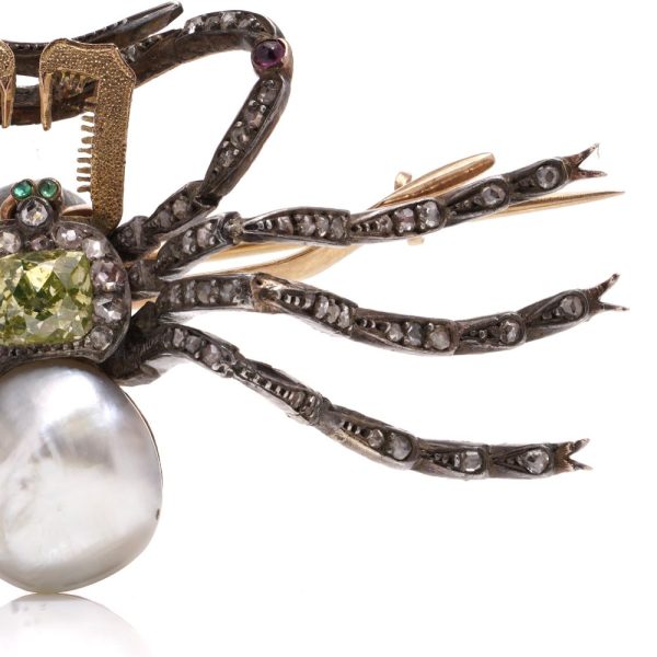 Antique spider brooch with diamonds, pearl, rubies and emeralds in gold and silver.