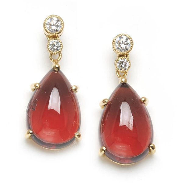 Diamond topped garnet drop earrings mounted in gold.