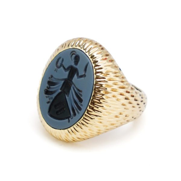 Gold signet ring with an oval carved sardonyx intaglio.