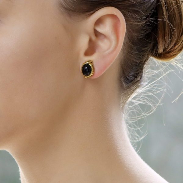 Onyx cabochon clip-on earrings in gold.