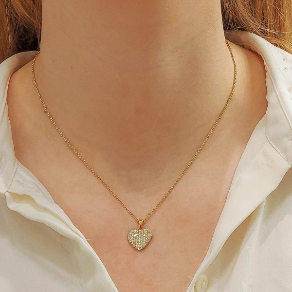 A diamond heart pendant in gold.