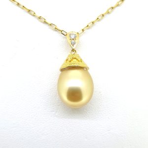 Golden South Sea Pearl Pendant with Chain, elegant golden South Sea pearl sits under a detailed 18ct yellow gold cap suspended from a diamond set bale on a 48cm chain