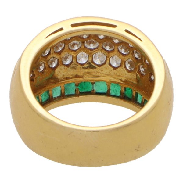 Vintage emerald and diamond bombe ring in yellow gold.