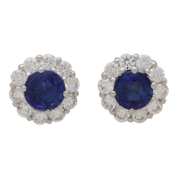 Sapphire and diamond cluster earrings set in white gold.