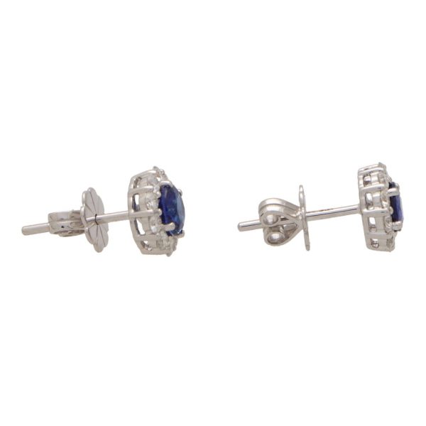 Sapphire and diamond cluster earrings set in white gold.