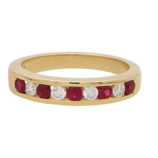 Ruby and diamond half eternity ring set in yellow gold.