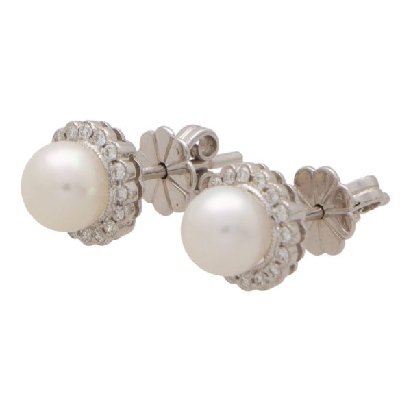 Pearl and diamond cluster earrings in white gold.