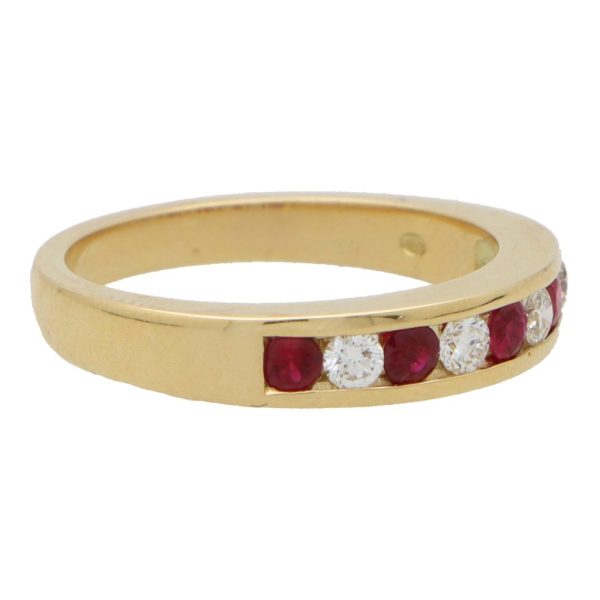 Ruby and diamond half eternity ring set in yellow gold.