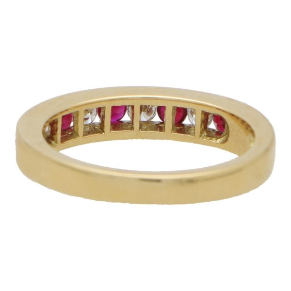 Ruby and diamond half eternity ring set in yellow gold.