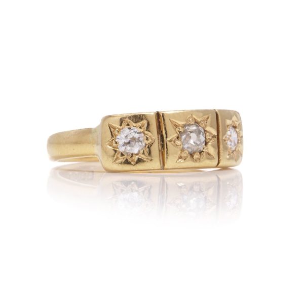 Vintage three-stone diamond ring in gold.