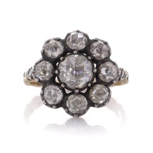 Diamond daisy cluster ring in gold and silver.