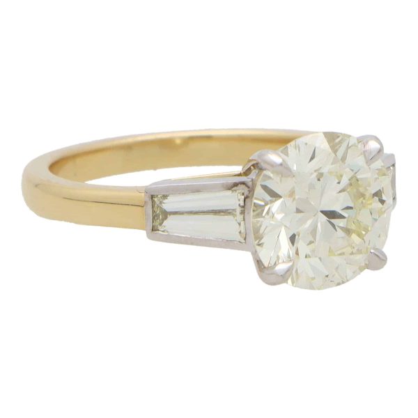 Vintage 2.56 carat diamond three stone ring in yellow gold and platinum.