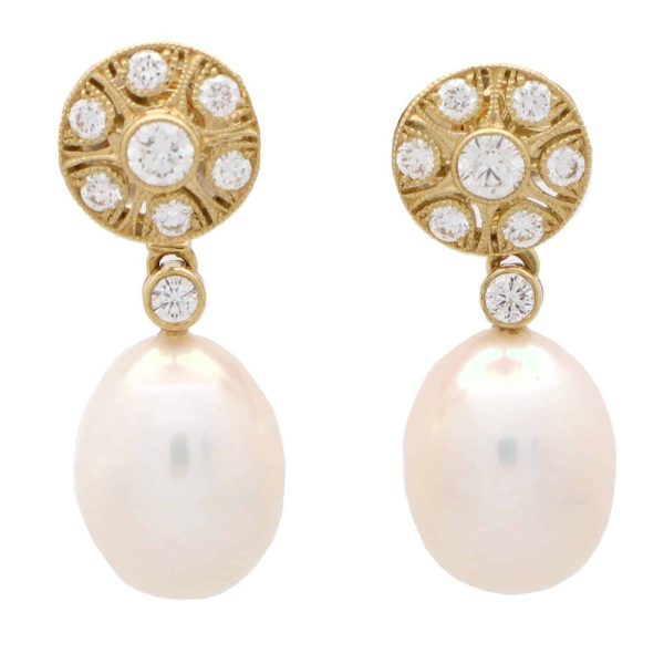 Convertible pearl and diamond earrings in gold.
