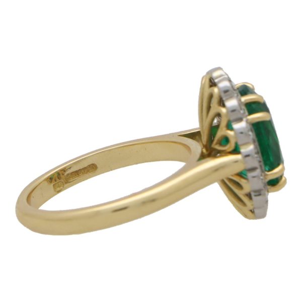 Emerald and diamond cluster ring in gold and platinum.