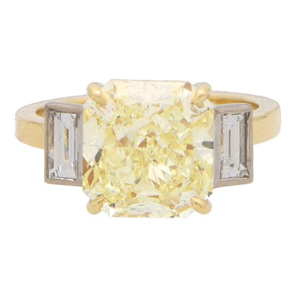 Natural 5.03 carat yellow diamond ring set in yellow gold and platinum.