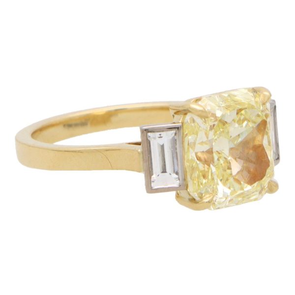 Natural 5.03 carat yellow diamond ring set in yellow gold and platinum.