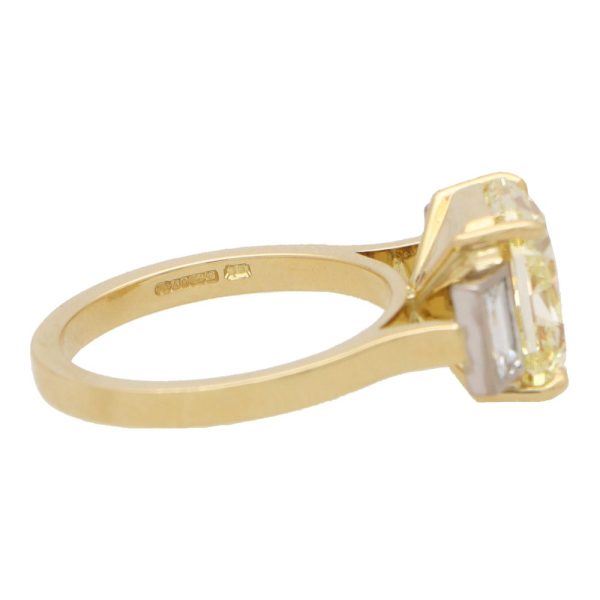 Natural 5.03 carat yellow diamond ring set in yellow gold and platinum.