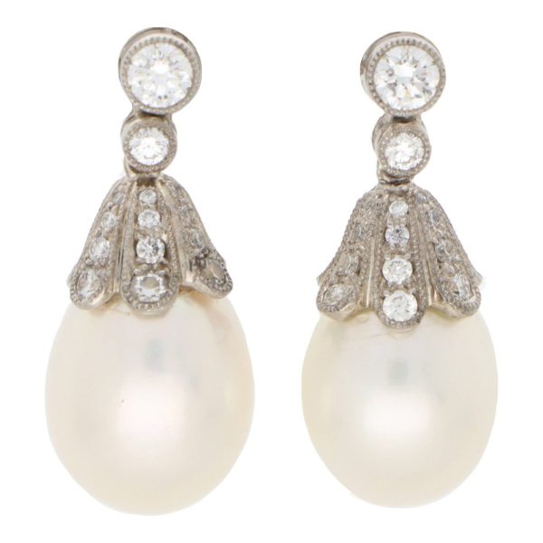 Pearl and diamond drop earrings in white gold.
