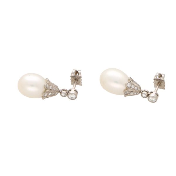 Pearl and diamond drop earrings in white gold.