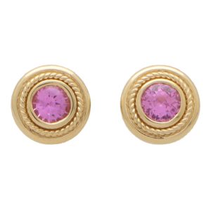 Pink sapphire stud earrings set in yellow gold.
