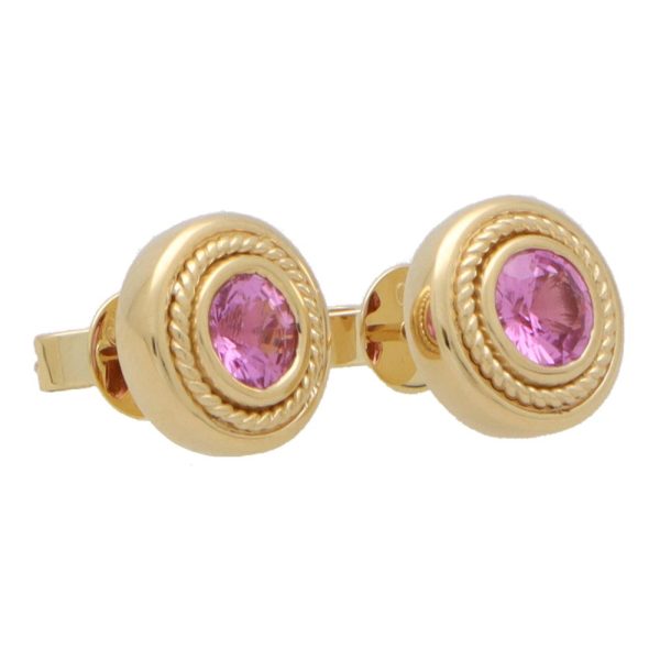 Pink sapphire stud earrings set in yellow gold.