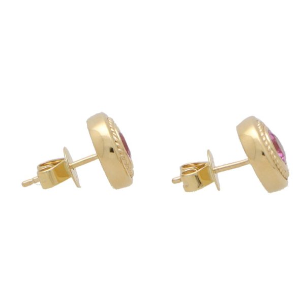 Pink sapphire stud earrings set in yellow gold.