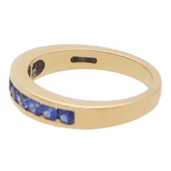 Sapphire half eternity ring set in 18 carat yellow gold.
