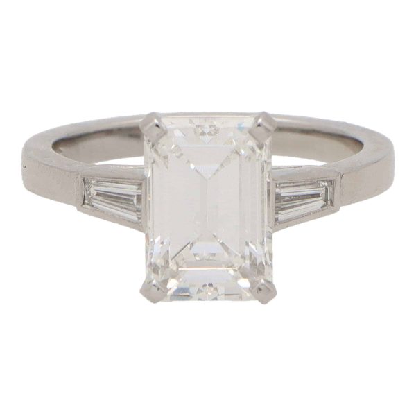 Emerald cut diamond three stone ring set in platinum.