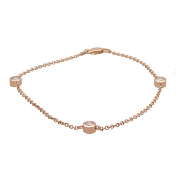 Diamond three stone chain link bracelet in rose gold.