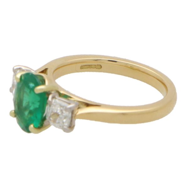 Diamond and emerald three stone ring in yellow and white gold.