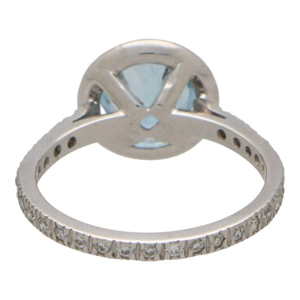 Aquamarine and diamond halo ring set in platinum.