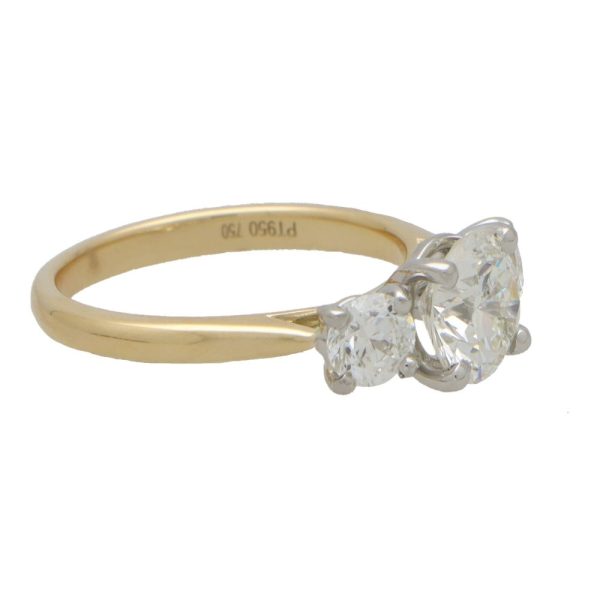 Diamond three stone engagement ring in yellow and white gold.