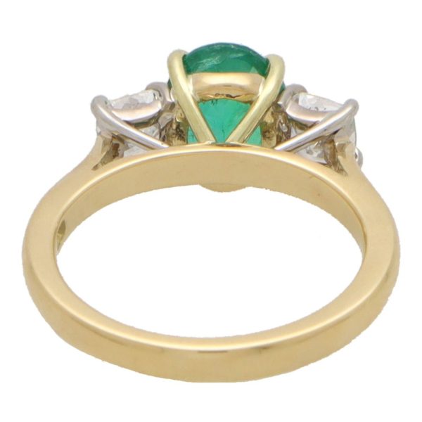 Diamond and emerald three stone ring in yellow and white gold.