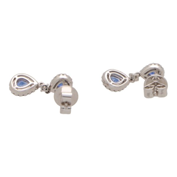 Sapphire and diamond cluster drop earrings in white gold.