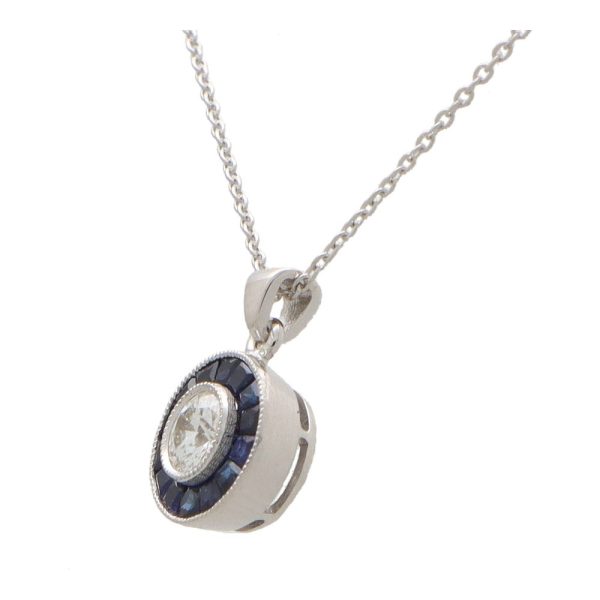 Diamond and sapphire target necklace in white gold.