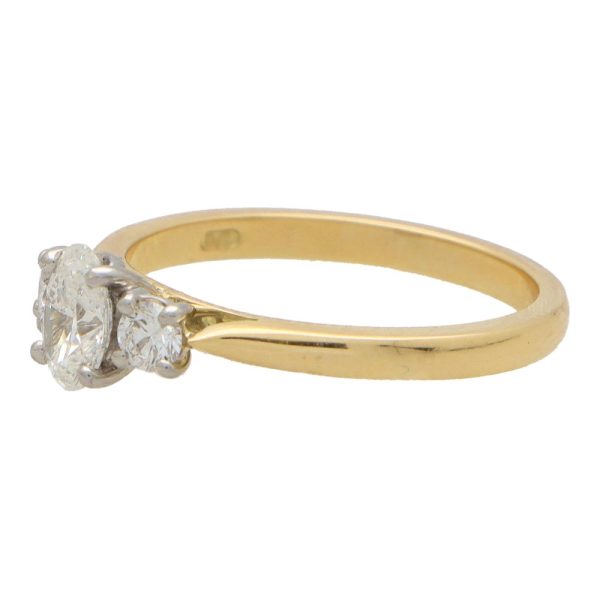 Diamond three stone ring in yellow gold and platinum.