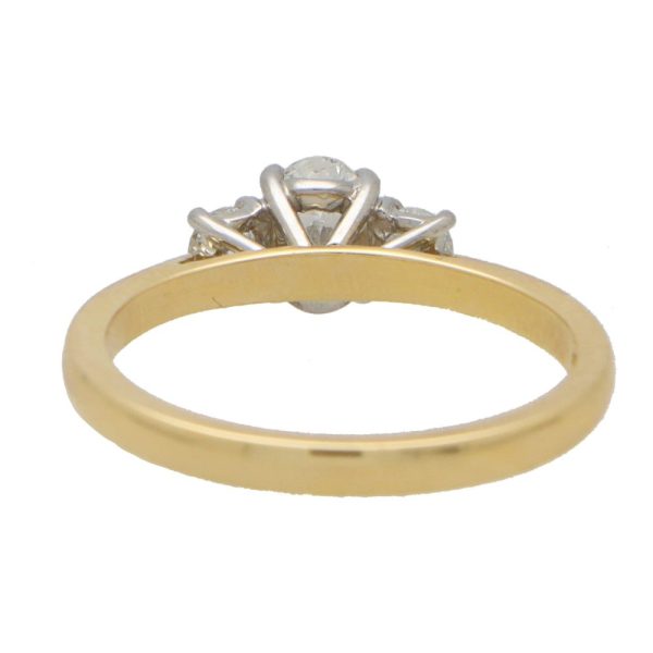 Diamond three stone ring in yellow gold and platinum.