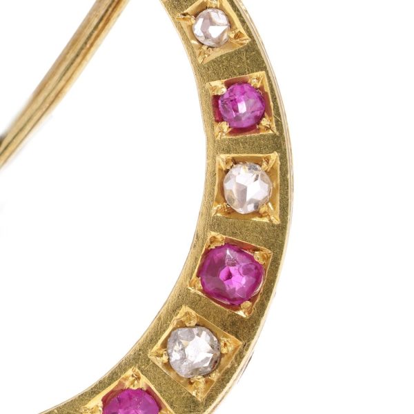 Victorian diamond and ruby crescent brooch in gold.
